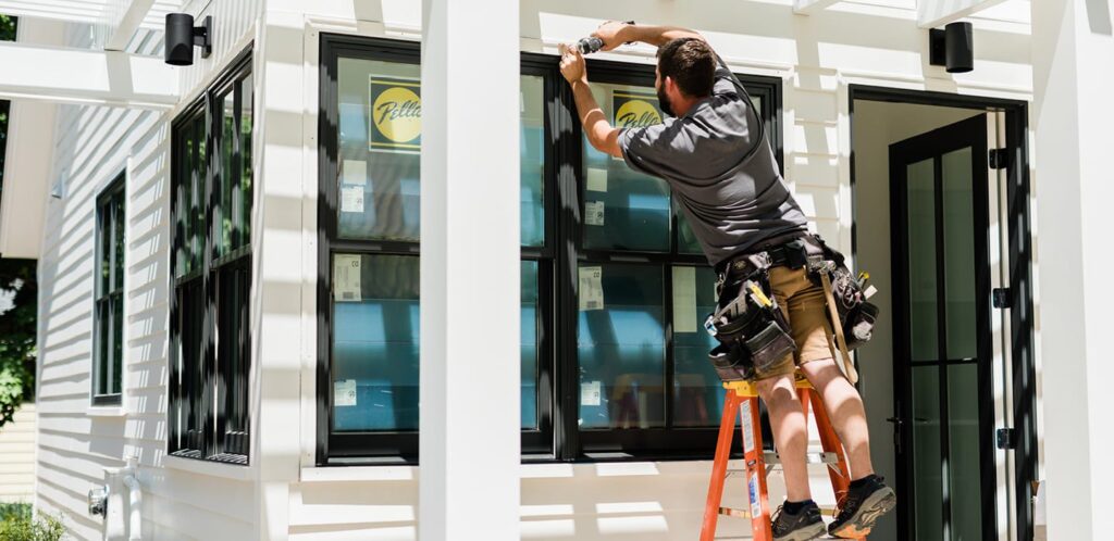 Installer fitting an aluminium window